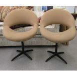 A pair of 1960s moulded, mushroom coloured fabric upholstered office reception chairs, raised on