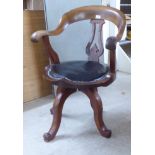 A late Victorian mahogany framed, horseshoe shape back desk chair with a simply carved splat and