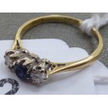 An 18ct gold sapphire and diamond three stone ring