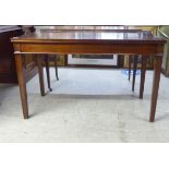 An early 20thC string inlaid mahogany serving table with a level, deep apron, raised on moulded,