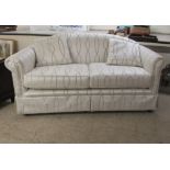 A modern two person settee, upholstered in two tone silver coloured patterned fabric with an