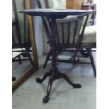 A George III design string inlaid and marquetry mahogany pedestal table, raised on a tripod base