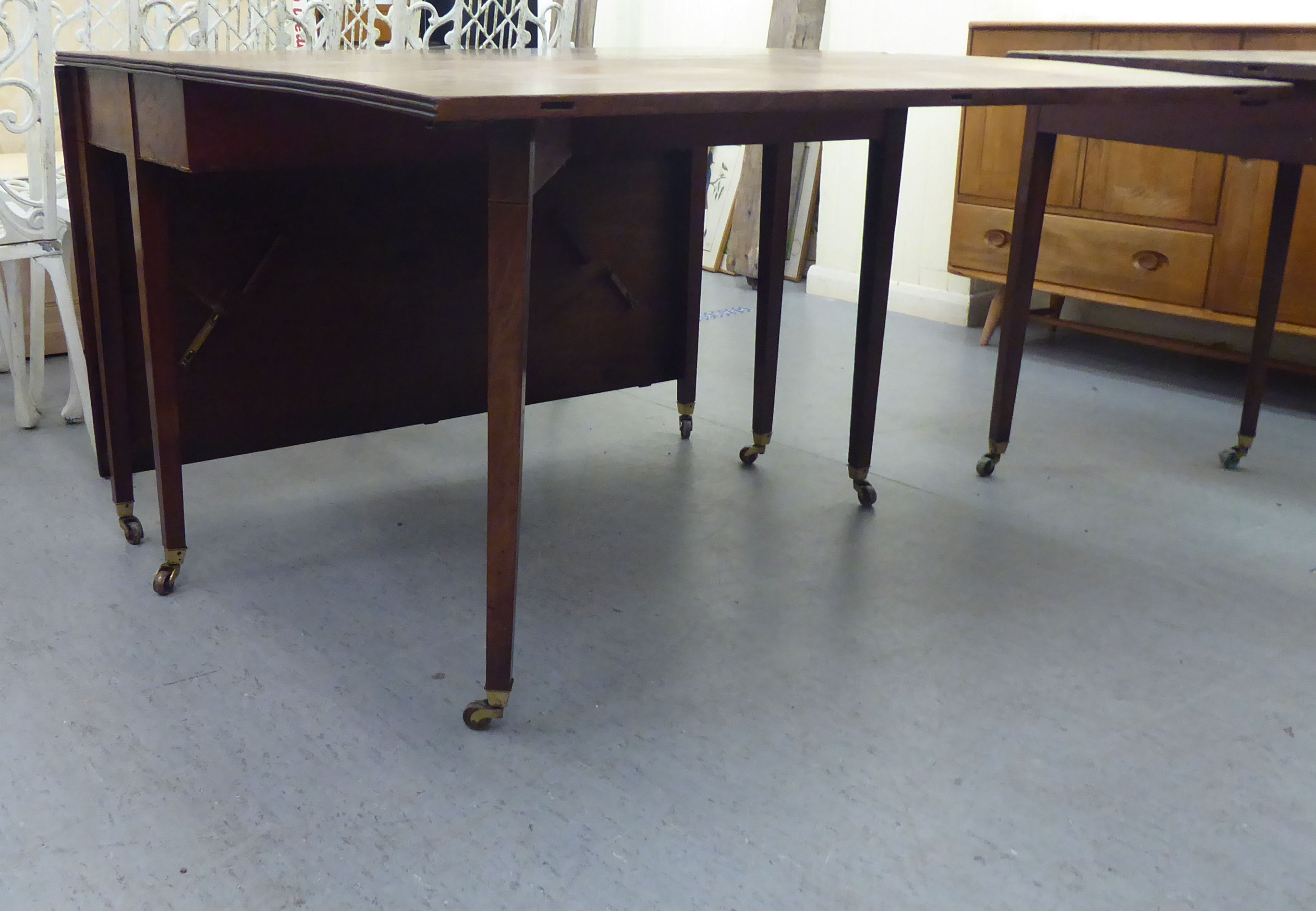 A George III mahogany dining table, comprising a drop leaf centre section and two D-ends, raised - Image 4 of 4