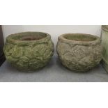 A pair of composition stone planters of fish bowl form, decorated in relief with flora  13"h  15"dia