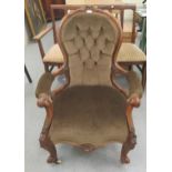 A late Victorian floral and scroll carved walnut showwood framed spoonback chair with open arms,
