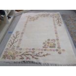 A modern woollen rug, decorated with flora, on a cream coloured ground  74" x 92"
