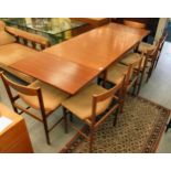 A G-Plan teak draw leaf dining table, raised on turned, tapered legs  28.5"h  34"w  59"L with two