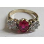 A 9ct gold ring, claw set with a simulated ruby, flanked by two cubic zirconias  boxed