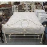 A Laura Ashley Victorian style cream coloured iron framed double bed with a slatted base and