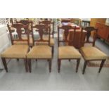 A late Victorian set of six carved mahogany framed boudoir chairs, each with a bar crest and vase