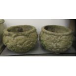 A pair of composition stone planters of fish bowl form, decorated in relief with flora  13"h  15"dia