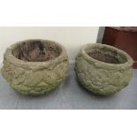 A pair of composition stone planters of fish bowl form, decorated in relief with flora  13"h  15"dia