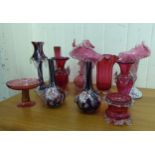 Cranberry and similarly coloured glass of varying designs: to include a pair of bottle vases,