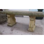 A composition stone terrace bench, the rectangular seat raised on two pedestals  19"h  47"w