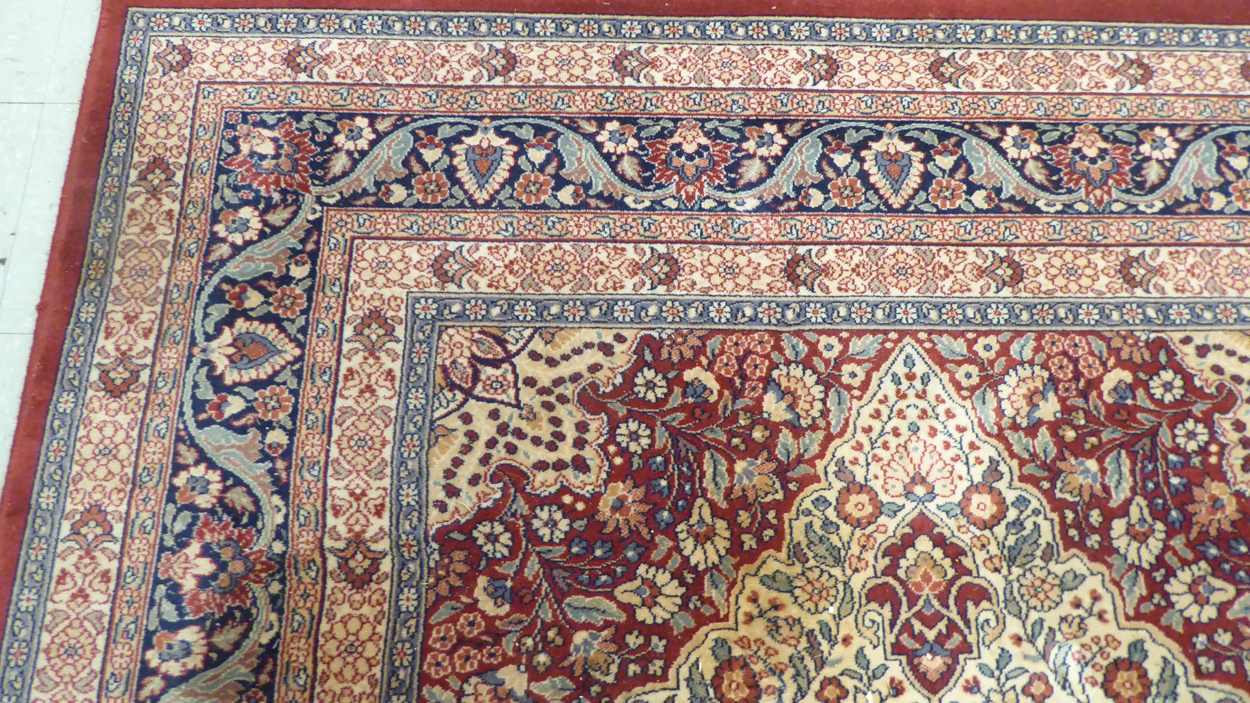 A modern Persian design machine made rug, decorated with flora in bright colours, on a red ground - Image 3 of 4