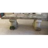 A composition stone terrace bench, the rectangular seat raised on two pedestals  17"h  55"w