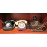 Three dissimilar telephone handsets: to include an early 20thC wall mounted example with a dial-up