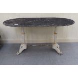 A 20thC terrace table, the weathered stone, oval top on a white painted cast iron underframe  17"