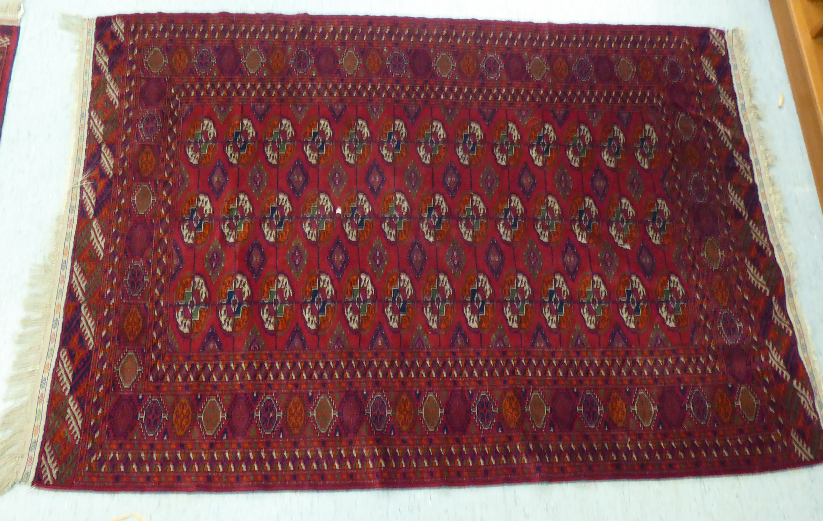 A Turkoman rug  39" x 58"; and another similar  46" x 66" each on a red ground - Image 3 of 5