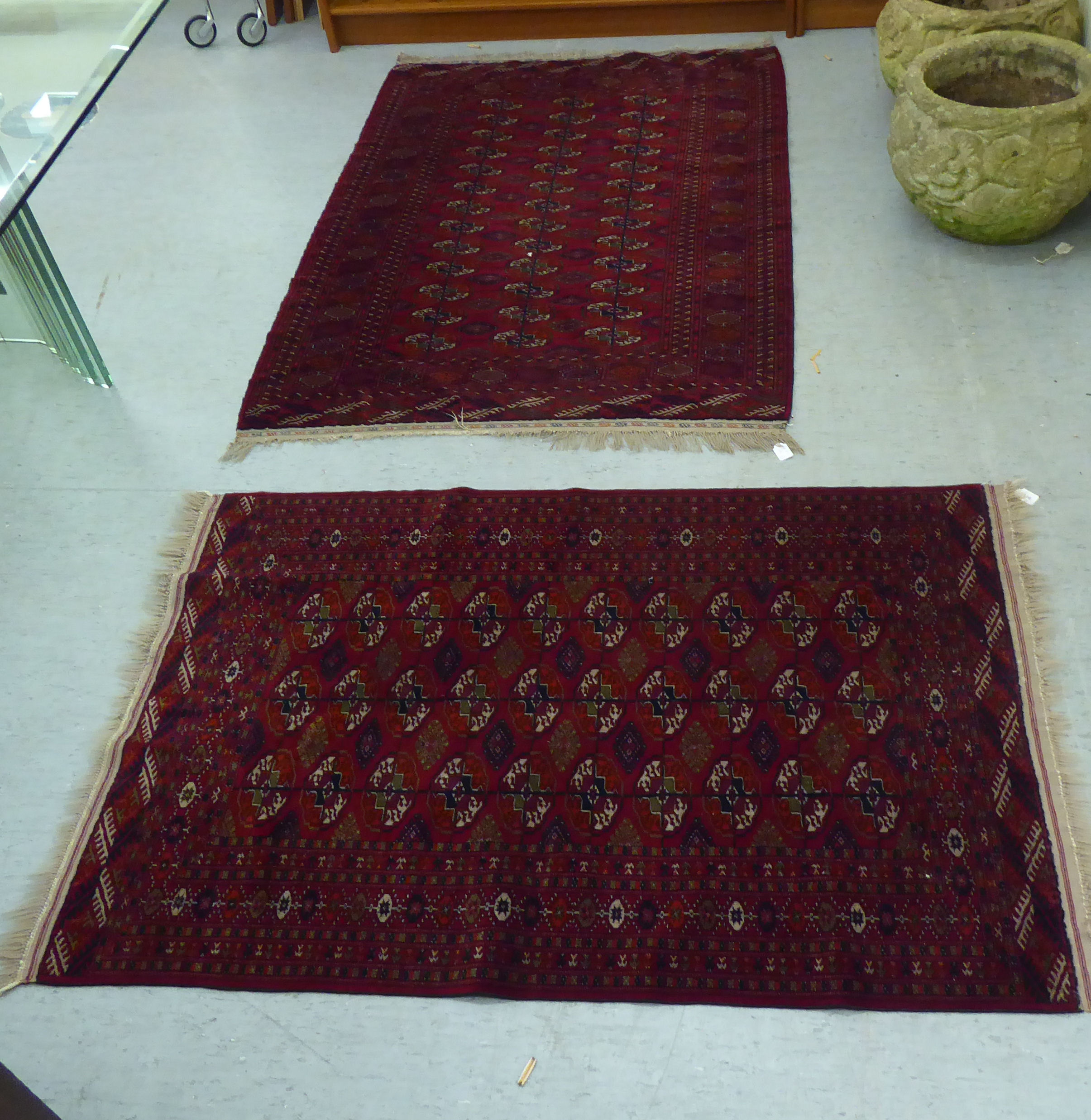 A Turkoman rug  39" x 58"; and another similar  46" x 66" each on a red ground