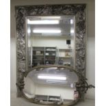 Mirrors: to include an example in a silver painted frame, carved with musical instruments  24" x 18"