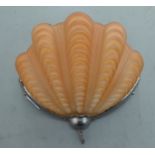 A 1930s Art Deco chromium finished wall light with an amber glass shell design shade  11"dia