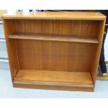 A modern teak open front, two tier bookcase, on a plinth  34"h  38"w