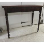 An early 19thC mahogany tea table, the rotating foldover top over a straight frieze, raised on