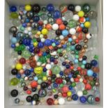 A collection of clear and coloured glass marbles  various sizes