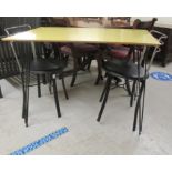 A 1960s canary yellow laminate topped kitchen table, raised on black painted steel wire cluster legs