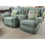 A pair of modern wingback armchairs, upholstered in patterned and cushioned, pale green tasselled
