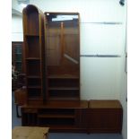 A 1970s/80s modular teak livingroom unit with an arrangement of glazed, open and drawer/door