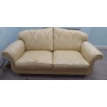 A modern Omega Furniture three person settee, upholstered in patterned cream coloured fabric, raised