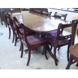 A modern Regency style mahogany and rosewood dining table with inlaid brass and crossbanded