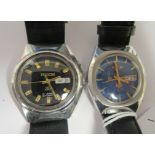 Two vintage Ricoh automatic stainless steel cased wristwatches, each faced by a baton dial with a