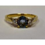 An 18ct gold claw set, aqua and diamond ring