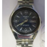 A vintage Seiko 5 automatic, stainless steel cased bracelet watch, faced by a blue Roman dial with