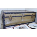 An early 20thC Watajoy of London cabin trunk with khaki painted and rivetted iron reinforcement,