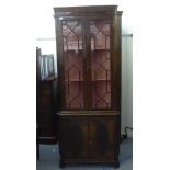 A modern reproduction of a 19thC mahogany two part standing corner cupboard with a dentil moulded