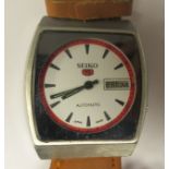 A vintage Seiko 5 automatic, stainless steel cased wristwatch, faced by a white baton dial, on a