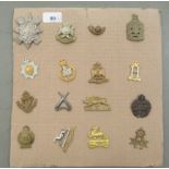 Sixteen regimental cap badges and other insignia, some copies: to include The Royal Berkshire, The