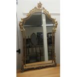 A modern mirror, the arched plate with separate margin slips, set in an ornate gilt frame  42" x 24"