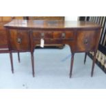 A Regency mahogany bow front sideboard with a central drawer, flanked by a cellarette drawer and a