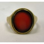 A 9ct gold signet ring, set with an amber coloured stone