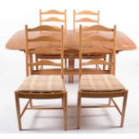 Ercol: modern elm refectory style extending dining table; and four dining chairs.