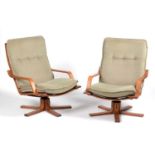 Pair of laminated beechwood swivel armchairs.