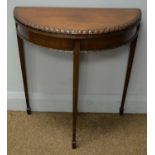 A mahogany demi lune card table