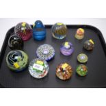 A selection of coloured glass paperweights.
