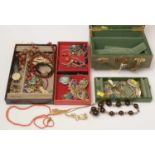 A jewellery box containing a quantity of costume jewellery.