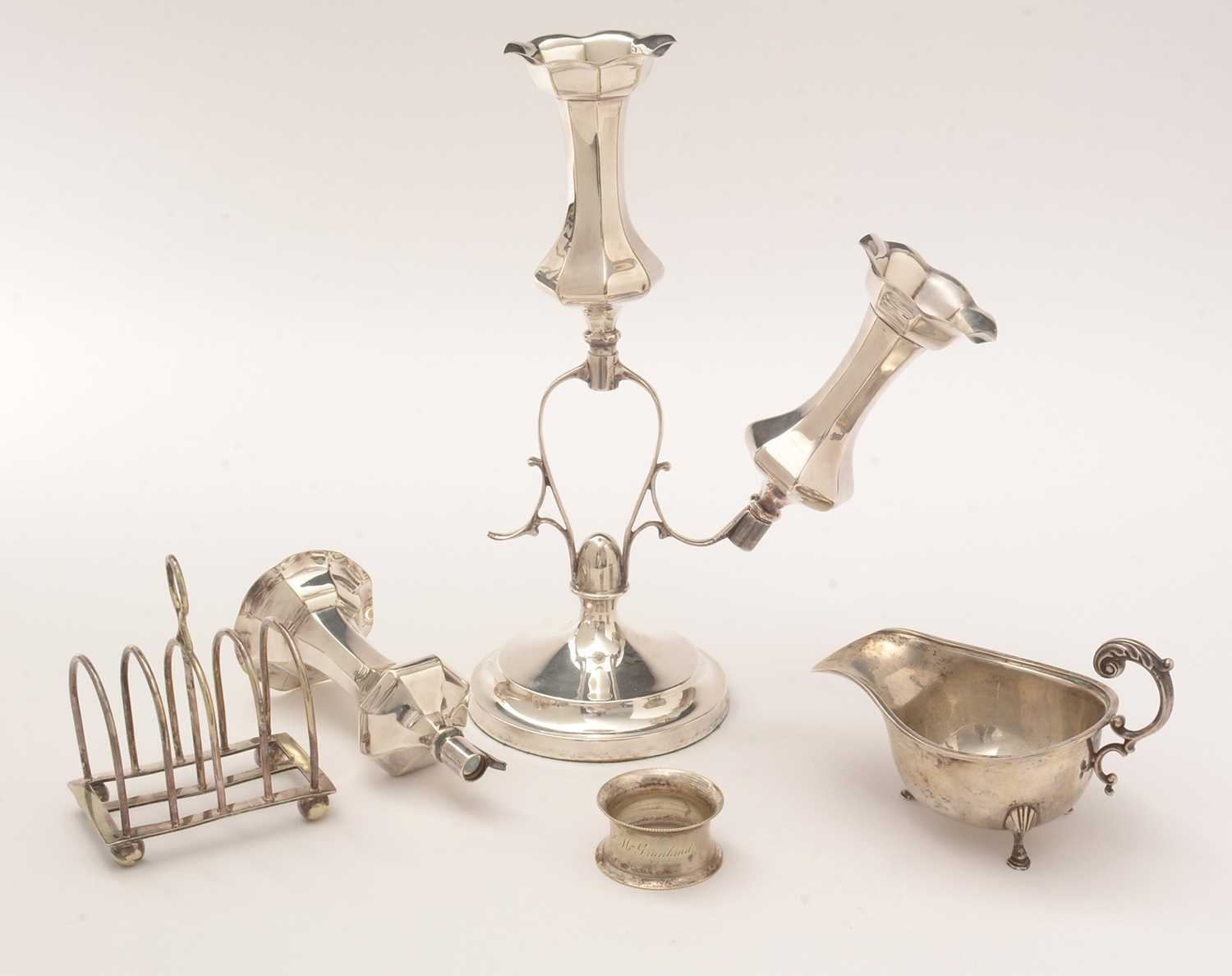 A silver sauce boat and sundry electroplate items.